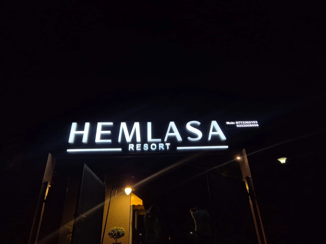 Resort entrance sign at night — photograph from the property’s Google listing